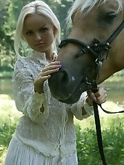 Pretty blonde riding horse naked in woods